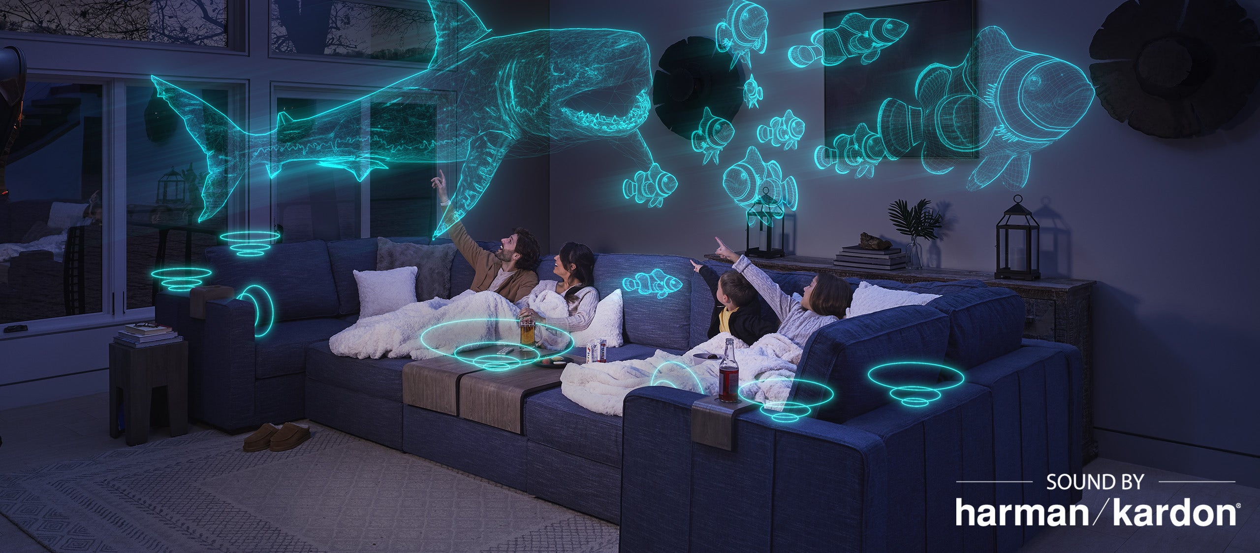 Family enjoying their StealthTech Sound + Charge System that is hidden inside  their Lovesac Sactionals couch