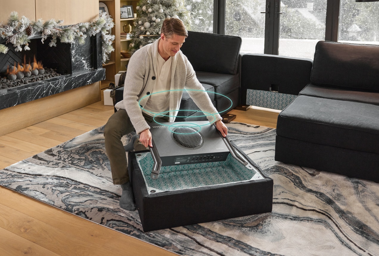 Woman Upgrading Lovesac Sactional with StealthTech Subwoofer
