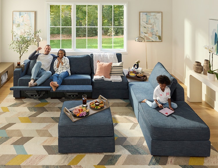 Family relaxing on their blue Lovesac sectional couch